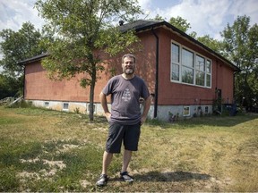 Jeffrey Taylor stands outside a former school house which he turned into his home and pottery studio in the village of Duval.