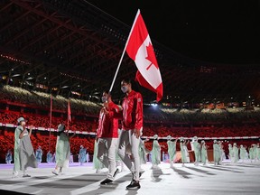 Flag bearers Miranda Ayim and Nathan Hirayama of Team Canada lead their team during the Opening Ceremony.