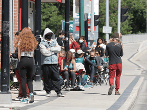 People line up outside a COVID-19 vaccination walk-in clinic in Winnipeg, June 22, 2021.