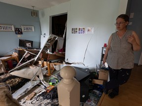 Holly Parent shows the damage done by a truck that crashed through her house at 2:30 a.m. on Aug. 18. Photo taken in Saskatoon, Sask. on Thursday, August 19, 2021.