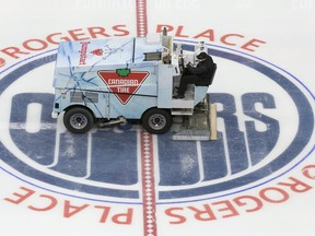 A zamboni driver wearing a face mask floods the ice during the first day of the Edmonton Oilers training camp for the 2019-20 NHL return to play venture at Rogers Place on Monday, July 13, 2020.