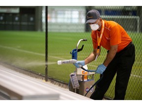 Ashok Kumar of Evraz Place demonstrates the use of a sanitizing chemical machine following a news conference, regarding increased cleaning protocols for Evraz Place facilities, at the AffinityPlex in Regina, Saskatchewan on August 4, 2021.