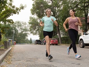 Physiotherapist Kim Fraser (right) runs with client Heather Morrison outside Still Physiotherapy
