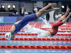 Turkey's Sevilay Ozturk (L) competes during the final of women's 200m freestyle (S5) at the Tokyo 2020 Paralympic Games at Tokyo Aquatics Centre in Tokyo on August 25, 2021.