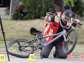 Police investigate the scene after a cyclist was taken to hospital after being hit by a car on the 400 block of Forest Way S.E. Traffic in neighbourhood is still blocked off. Wednesday, August 11, 2021. Brendan Miller/Postmedia