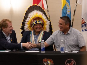 (From left) Indigenous Services Minister Marc Miller, Saskatoon Tribal Council Chief Mark Arcand and Chief Daryl Watson shake hands during the signing of the funding agreement that gives full control of child welfare to STC in member nations. Photo taken in Saskatoon, Sask. on Wednesday, August 5, 2021. (Saskatoon StarPhoenix / Michelle Berg)