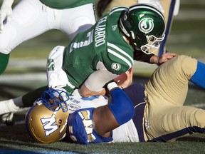 Columnist Rob Vanstone wonders whether a patchwork offensive line will be able to adequately protect Saskatchewan Roughriders quarterback Cody Fajardo, who is shown being sacked by the Winnipeg Blue Bombers' Drake Nevis in the CFL's 2019 West Division final at Mosaic Stadium.
