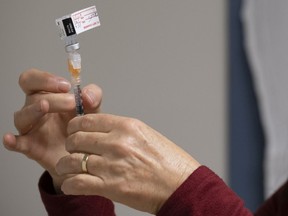 A nurse clinician prepares a syringe with the Pfizer-BioNTech COVID-19 vaccine at the Regina General Hospital in Regina on Tuesday Dec. 15, 2020.