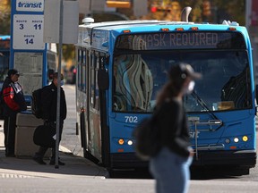 SASKATOON, SK-- Masked transit users board a bus at the downtown bus mall. Photo taken in Saskatoon on Friday, Sept. 24, 2021.