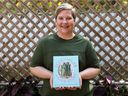 Renee Kohlman holds up her new cookbook, Vegetables A Love Story.
