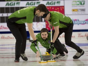 Matt Dunstone, aided by sweepers Kirk Muyres, left, and Dustin Kidby, throws a rock at the 2021 Brier. Michael Burns/Curling Canada.