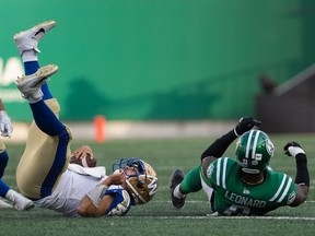 Saskatchewan Roughriders defensive end A.C. Leonard, right, tackles Winnipeg Blue Bombers quarterback Zach Collaros during Sunday's Labour Day Classic. Leonard is to sit out Saturday's rematch in Winnipeg after receiving a two-game, league-issued suspension.
