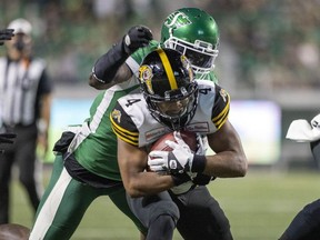 Saskatchewan Roughriders defensive end A.C. Leonard, shown here tackling on Papi White of the Hamilton Tiger-Cats, has been suspended by the CFL for another game for verbal abuse and unacceptable behaviour towards doping control officers. TROY FLEECE / Regina Leader-Post