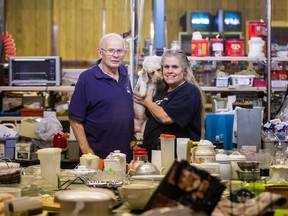 Barrie Rose, left, and his daughter Gail Rose stand with their dog Max. The Roses are owners of Rose's Furniture and Auction LTD. They are closing their doors after 85 years in business. Photo taken in Saskatoon on Oct. 14, 2021.