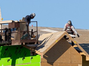 Contractors work on a house in Saskatoon on Wednesday, October 20, 2021.