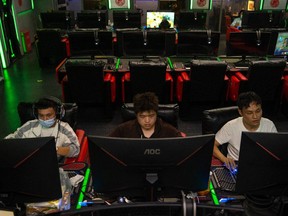 People play online video games in a game arcade on Sept. 11, 2021 in Beijing, China.