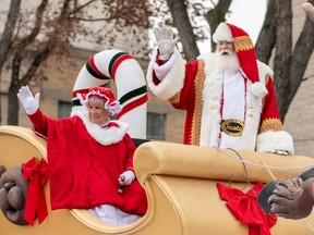 Mrs Claus, left, and Santa Claus, right, wave at the crowd during the Santa Claus Parade in downtown Saskatoon, Nov. 17, 2019.