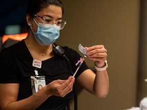 A nurse draws a dose of Pfizer-BioNTech vaccine at the Saskatoon Tribal Council (STC) COVID-19 vaccine clinic in the Sasktel Centre. The STC is running the clinic in partnership with the Saskatchewan Health Authority. Photo taken in Saskatoon, SK on Friday, April 9, 2021.