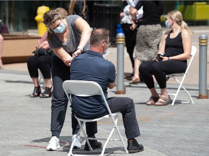  A man gets a vaccination at a pop-up COVID-19 vaccine clinic on Scarth Street in Regina in June 2021.