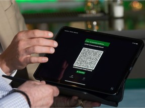A new smart device app to display a QR code for proof of COVID-19 vaccination is shown on a tablet at Memories Fine Dining in Regina, Saskatchewan.