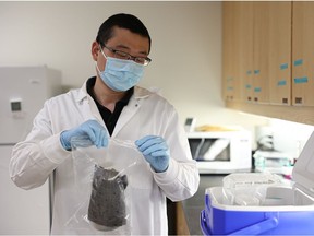 Dr. Yuwei Xie holds a "fresh" sample of wastewater from the City of Saskatoon.