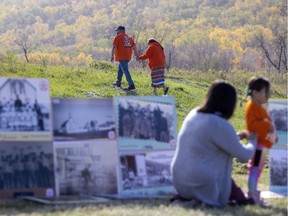 A couple holds hands during an event on the National Day for Truth and Reconciliation on Sept. 30, 2021 on the Cowessess First Nation.