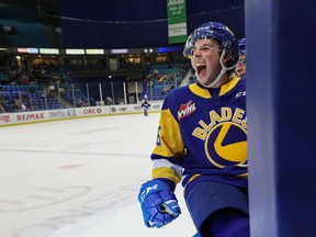 Saskatoon Blades' Kyle Crnkovic celebrates his teammate's goal from the bench during first period action of the home opener game against Moose Jaw Warriors at SaskTel Centre. Photo taken in Saskatoon on Saturday, October 2, 2021.