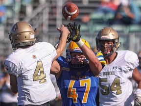 Saskatoon Hilltops defensive lineman Riece Kack tries to block a pass during first half action against Edmonton Huskies in a Prairie Football Conference game at SMF Field. Photo taken in Saskatoon on Sunday, October 3, 2021.