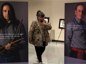 A survivor takes in the traveling exhibit that tells the history of the Sixties Scoop at the Saskatoon Western Development Museum.