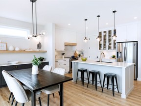 "Modern, fresh and airy" is how Pure Developments' designer Jade Cox describes their new show home located at 545 Dubois Manor in Brighton. The kitchen's white Shaker-style cabinets are complemented by warm wood accents, gold hardware, black pendant lights and a black undermount sink.
