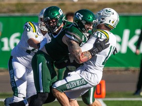 Huskies' linebacker Nick Wiebe puts a hit on Alberta quarterback Luke Hornung during a Canada West game this past Saturday.