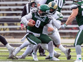 Regina Rams' defensive lineman Anthony Bennett grabs the facemask of Saskatchewan Huskies' quarterback Mason Nyhus while making a tackle on Saturday. Bennett was penalized for face-masking on the play.