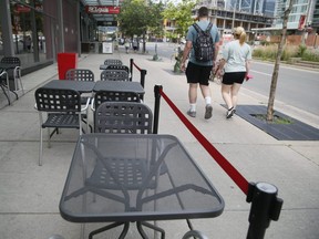 Empty tables outside of a downtown Toronto restaurant on Sunday July 18, 2021.