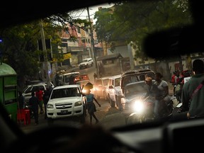 Motorists and pedestrians move through a street on July 24 in Port-au-Prince, Haiti.