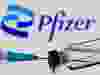 Syringe and vial are seen in front of displayed new Pfizer logo in this illustration taken, June 24, 2021.