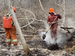 Red Earth Cree Nation fire crews fight to put out a blaze near their home community. Photo provided by Prince Albert Grand Council on Oct. 15. (Saskatoon StarPhoenix).