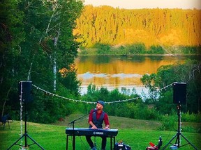 Jeffery Straker performs at a private backyard concert this summer in Nipawin, with the Saskatchewan River in the background.