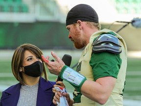A bloodied Sawyer Buettner is interviewed by Daniella Ponticelli after the University of Regina Rams quarterback scored a touchdown against the University of Calgary Dinos on Oct. 2 at Mosaic Stadium.