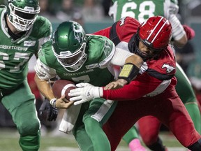 Saskatchewan Roughriders quarterback Cody Fajardo is sacked by the Calgary Stampeders' Mike Rose on Oct. 9 at Mosaic Stadium.