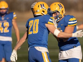Saskatoon Hilltops' defender Wade Keating celebrates with a teammate during PFC semifinal action Sunday against the Edmonton Huskies at SMF Field.