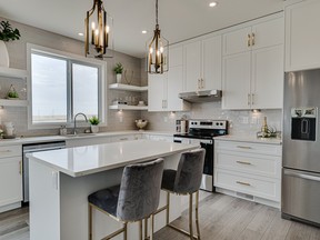 Luxe gold touches make a statement at North Ridge Development’s Everett show home at 574 Burgess Crescent in Rosewood. The kitchen sparkles with antique gold light fixtures and brushed gold cabinetry hardware. Photo: Scott Prokop Photography (www.repics.ca)