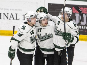 This trio of University of Saskatchewan Huskies, Jared Dmytriw, Donovan Neuls and Gordie Ballhorn, shown here celebrating a goal against the Manitoba Bisons, were among Canada's U Sports athletes slated to go to Switzerland for the FISU Winter Universiade World Games.