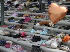 Children's shoes left as a tribute at the Saskatchewan Legislative Building in May. The items removed on Friday were from a later iteration of what had become a makeshift memorial to those found in unmarked graves near former residential schools.