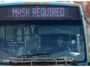 A masked bus driver waits for passengers at the downtown bus mall in Saskatoon on Sept. 24, 2021.