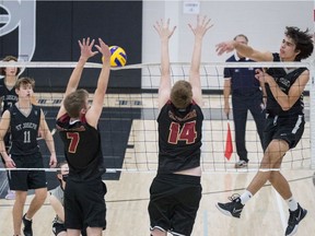 SASKATOON - St. Joseph beat Centennial to capture the 5A boys city volleyball championship Wednesday night. St. Joes' Lucas Musschoot (#15) goes for the kill with his teammates Ethan Libner (#11) and Carter Zenkewich (#7) looking on. Responding for Centennial are Ty Molle (#14) and Parker Williamson (#7). November 10, 2021.