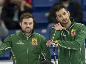 Skip Matt Dunstone (left) and third Colton Lott talk strategy Sunday at SaskTel Centre. Curling Canada/Michael Burns Photo