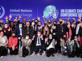 Delegates pose for a picture during the UN Climate Change Conference (COP26) in Glasgow, Scotland, Britain November 13, 2021.