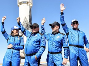 Blue Origins vice president of mission and flight operations Audrey Powers, Star Trek actor William Shatner, Planet Labs co-founder Chris Boshuizen and Medidata Solutions co-founder Glen de Vries wave during a media availability on the landing pad of Blue Origin’s New Shepard after they flew into space on October 13, 2021 near Van Horn, Texas.