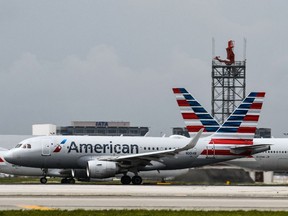 American Airlines planes taxi at Miami International Airport in Miami. (Photo by CHANDAN KHANNA / AFP)
