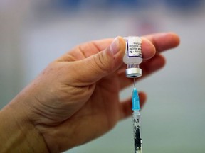 A health worker prepares a dose of the COVID-19 booster vaccine, amid the coronavirus disease (COVID-19) pandemic, at Midland House in Derby, Britain, September 20, 2021.